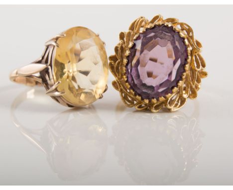 Two gemset dress rings, an oval mixed cut amethyst 15mm x 10mm, claw set in a yellow metal mount stamped 750 with textured sh