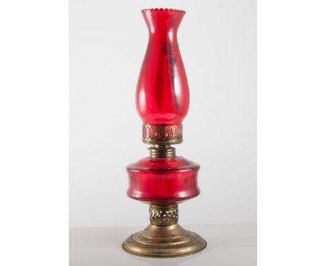 Oil lamp, ruby glass reservoir and chimney, 38cms and another brass oil lamp, (2).