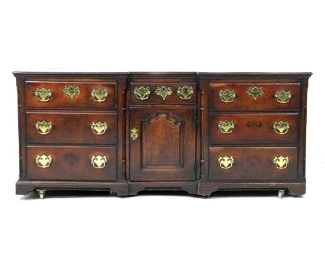 George II oak inverted breakfront dresser, circa 1730-50, two plank top over a central short drawer with shaped fielded panel