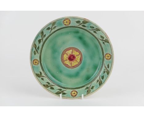 Della Robbia plate, circa 1894-96, simply decorated with a green ground centred with a rose and bordered with stylised flower