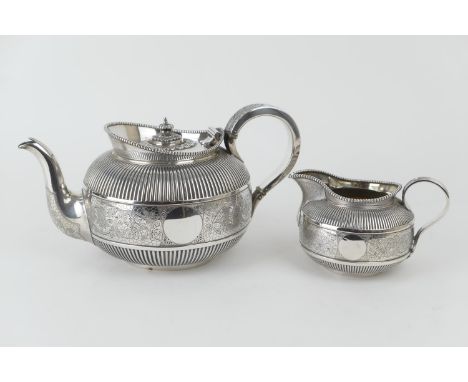 Victorian silver teapot and matching milk jug, by Martin Hall &amp; Co., London 1888, bun form with a floral engraved band to