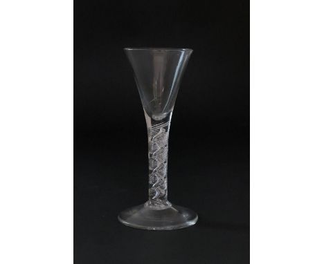 Late George II wine glass, circa 1750, drawn trumpet bowl over seven ply spiral band encasing a single corkscrew, height 18.5