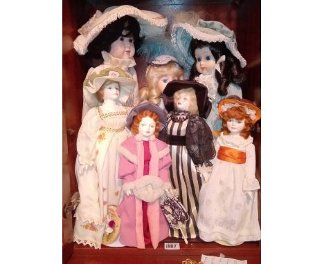 A shelf of seven decorative dolls