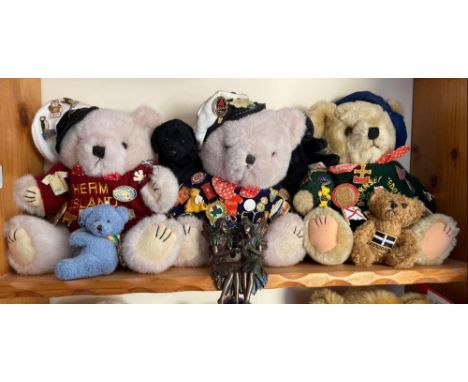A shelf with bears wearing enamel decorated badges