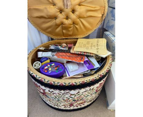 An oval tapestry work box with cotton reels etc