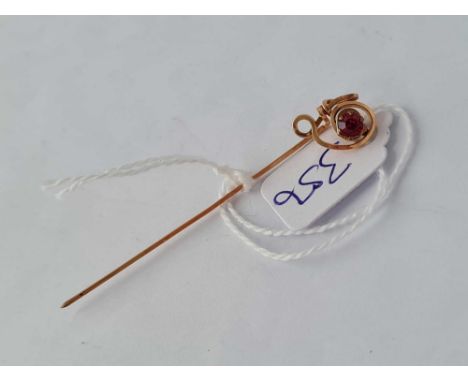 A single garnet stick pin.