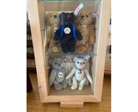  A group of five miniature Steiff Bears in glazed case