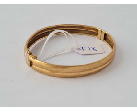 A plain hinged bangle 9ct - 10.6 gms 