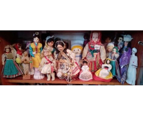 Shelf of oriental &amp; other dolls