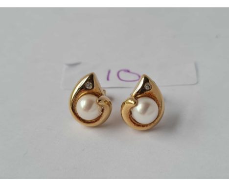 A pair of diamond set pearl earrings 18ct gold 