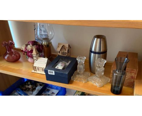 A shelf with Cranberry glass vase etc