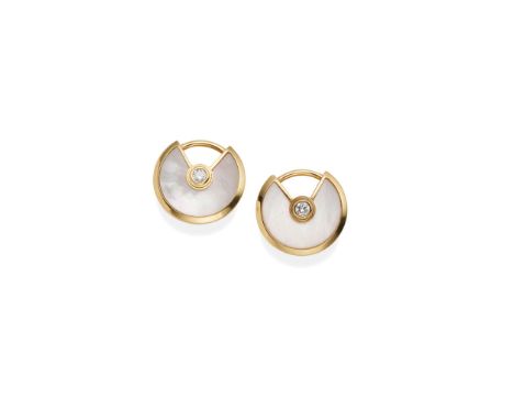  Cartier: A pair of mother-of-pearl 'Amulette de Cartier' earstuds  Each 18 carat gold disc, set with mother-of-pearl and cen