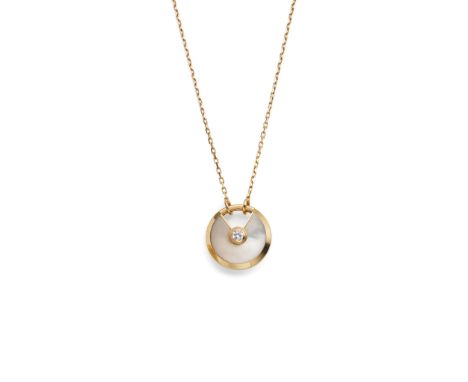  Cartier: A gold and mother-of-pearl 'Amulette de Cartier' necklace  The circular 18 carat gold pendant /clasp centrally feat