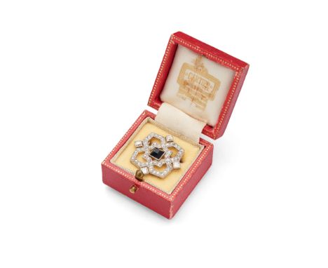  Cartier: An Art Deco onyx and diamond brooch circa 1920 Centrally set with a pyramidal-cut onyx, within an openwork geometri