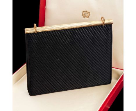  Cartier: A gold and silk handbag 1966-67 The reeded 9 carat gold spine featuring two ropetwist loops, to a ribbed black silk