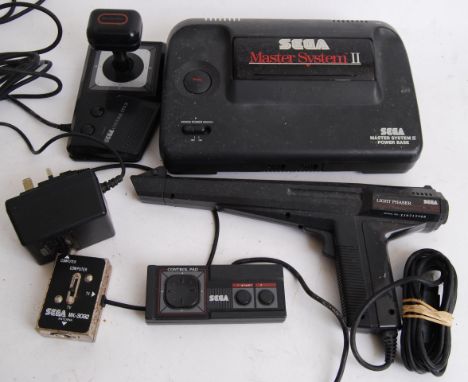 SEGA MASTER SYSTEM: An original SEGA master system II game console, with control pad, control stick and light phaser.

All it