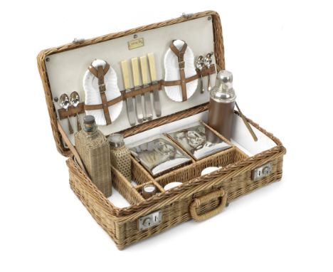 A wicker-cased 'Coracle' picnic set for four persons by G W Scott &amp; Sons, circa 1909,the wicker case with handle, nickell