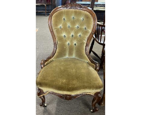 A Victorian button upholstered nursing chair with carved showwood frame, 90cm high