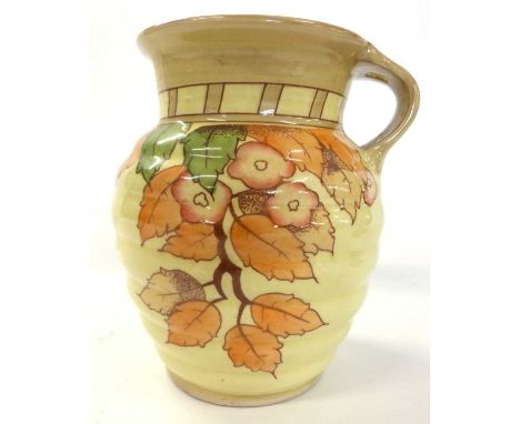 A Crown Ducal jug of ribbed form decorated with the autumn leaves pattern by Charlotte Rhead factory stamp and facsimile sign