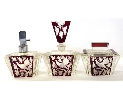 A 1920's Art Deco perfume set comprising a jar and cover, further atomiser and a further jar with stopper in typical Art Deco