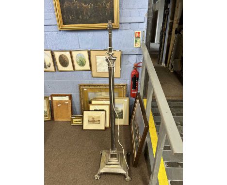 A 19th Century silver plated or alloy standard lamp of Corinthian column form raised on a stepped base with four paw feet, to