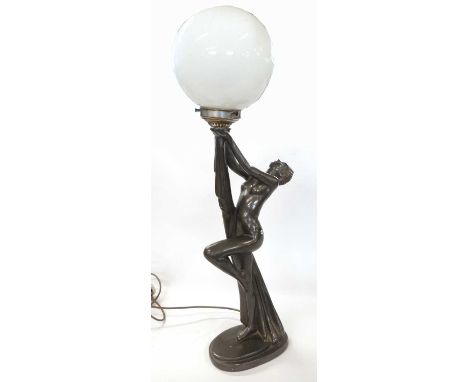 A large Art Deco figure of a nude lady holding a globular white glass lamp, the figure on a rectangular base, 53cm high