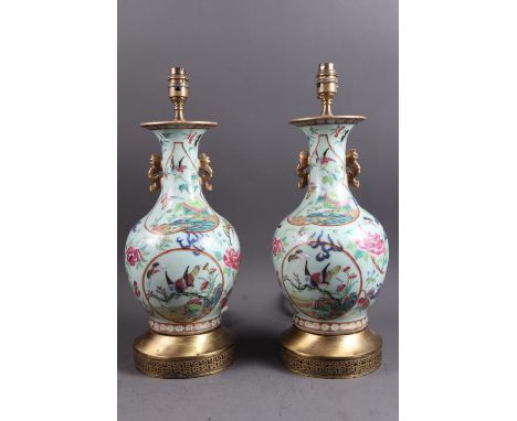 A pair of Chinese celadon and enamel glazed table lamps with mythical beast decoration, on brass bases, 17" highCondition:Som