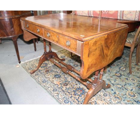 A well reproduced walnut and banded sofa table, fitted two drawers, on twin spindle turned and stretchered splay supports, 38