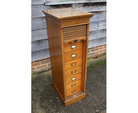 An early 20th century "Lebus Cabinet" oak tambour front cabinet with eight drawers, on block base, 14 1/2" wide x 19 1/4" dee