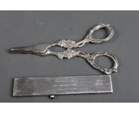 A pair of silver handled grape scissors and a silver mounted retractable comb set with blue cabochon 