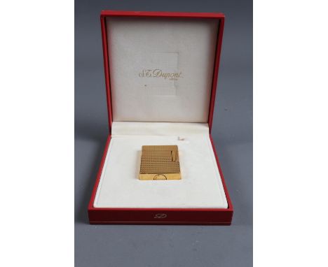 An ST Dupont gilt cased diamond point lighter, in original case, boxed