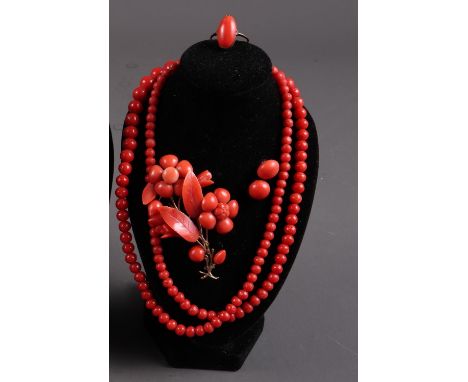 A red coloured coral jewellery set comprising a floral design brooch, earrings, 9ct gold dress ring size "K", 2.2g, and a gra