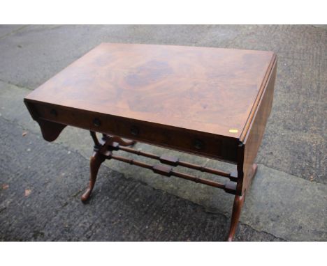 A figured walnut and banded sofa table, fitted two drawers, on twin turned end and splay supports, 59" wide x 22" deep x 28 1