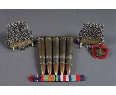 A pair of "Frontiersmen" chain epaulettes, a clip of five inert RL 39 shells, a set of WWII medal ribbons and a warrant offic