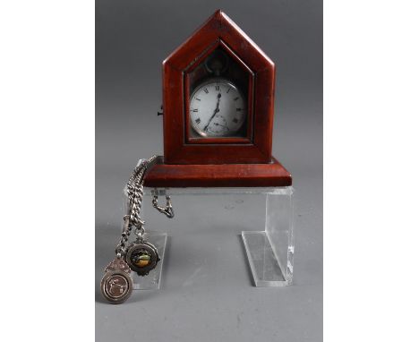 An engine turned silver cased pocket watch and chain with two fobs, 2.8oz troy, and a mahogany Gothic watch stand