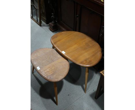 Two Ercol pebble shaped tables, on three turned tapering supports, (largest 25 1/2" wide)