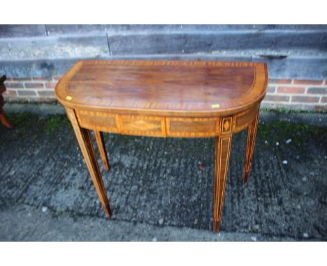An early 19th century kingwood, rosewood and satinwood banded fold-over top card table, on square taper supports, 36" wide x 