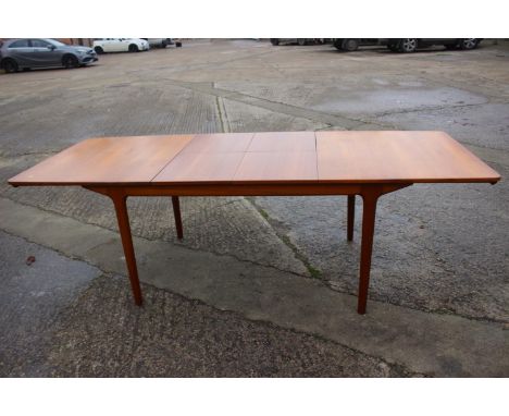 An A H McIntosh &amp; Co Ltd 1970s teak extending dining table with two extra integral leaves, 63" wide x 36" deep x 29" high
