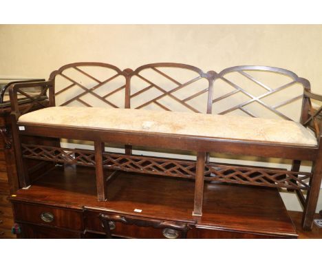 A mahogany chair back settee of Chinese Chippendale design with drop in seat, on stretchered supports, 66" wideCondition:Some