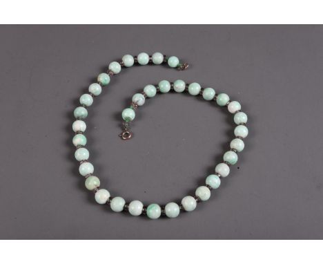A pale jade bead necklace, 17 1/2" long overallCondition:The beads are approximately 9.65mm in diameter.