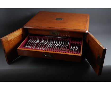 An oak canteen, containing a part table service of silver plated rattail pattern and another part table service of flatware