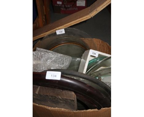 A quantity of long case clock glasses, mantel clock bezels and various other sizes of glasses and bezels