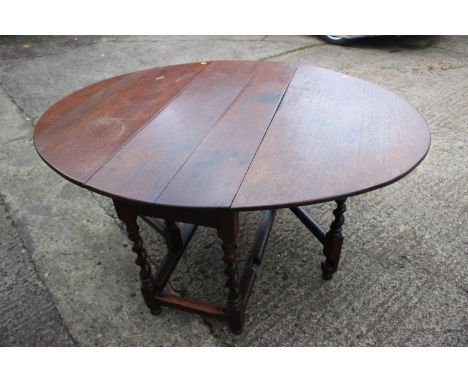 An early Georgian oval drop leaf dining table, on tapering barley twist gate leaf supports, 50" wide x 61" deep open x 29 1/2