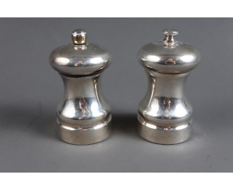 A pair of silver salt and pepper grinders, 3 1/2" high overallCondition:We cannot seem to remove the screw on the top of the 