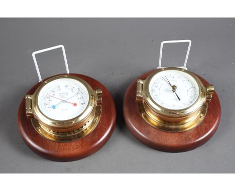 A "Wempe" brass cased barometer, on hardwood plaque, and a matching thermometer and hygrometer