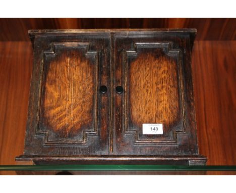 A VINTAGE OAK MINIATURE CUPBOARD