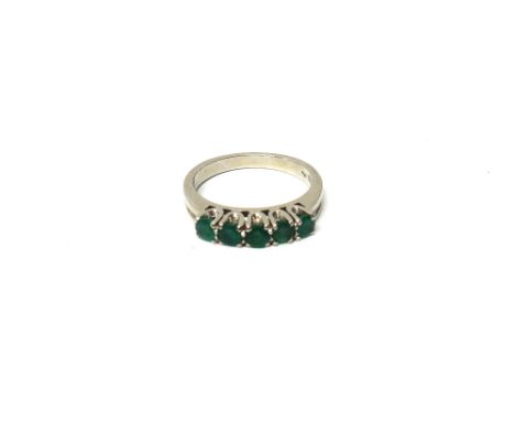 A white gold and emerald five stone ring, mounted with a row of circular cut emeralds, detailed 585, ring size O.