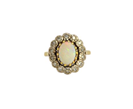 An 18ct gold, opal and diamond oval cluster ring, claw set with the oval opal at the centre, within a surround of circular cu