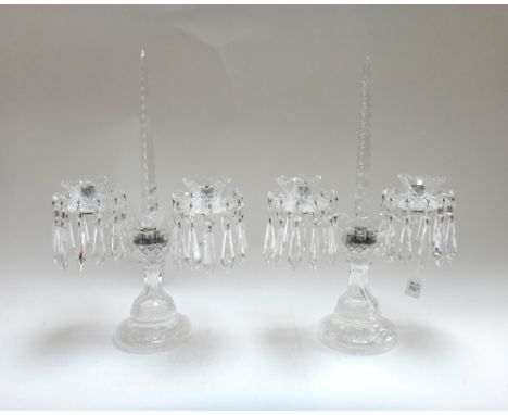 A pair of twin branch crystal candelabra, late 20th century, with central facet cut spire and two swan neck branches, over a 