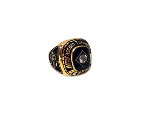 A gold, diamond set and black onyx American college style ring, mounted with a central circular cut diamond, on a black onyx 